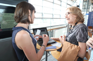 A member of GPC staff explaining to an interested guest thefeatures of GPC Online.